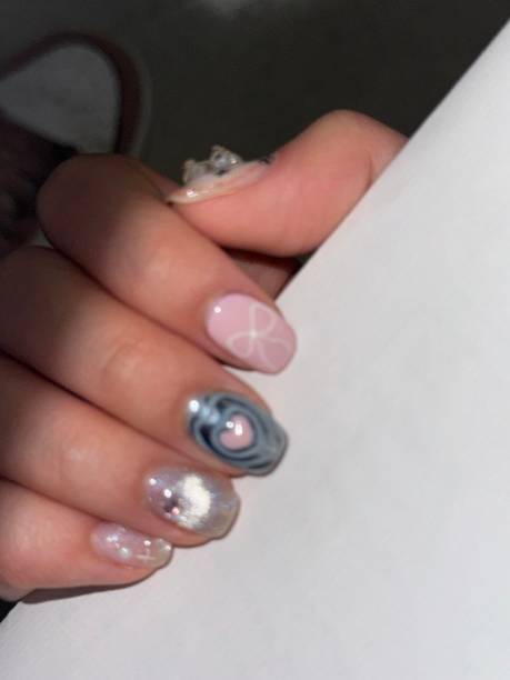 istock Creative nail art featuring intricate designs, vibrant colors, and unique patterns. Perfect for beauty and fashion photography, showcasing trends in nail designs and the artistry of manicure techniques. 2190036814