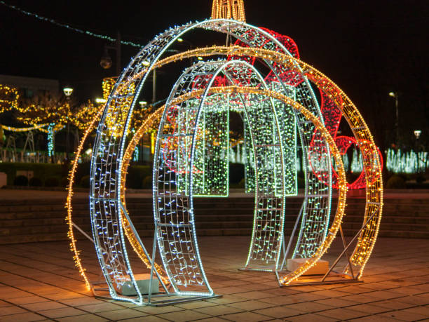 istock Decorative illuminated arches in a festive winter park setting at night 2190038090