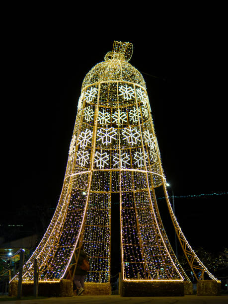 istock Large illuminated bell structure decorates festive night in a public square 2190038110