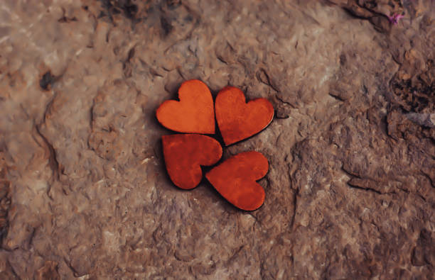 istock four red hearts on an old marble wall 2190038375