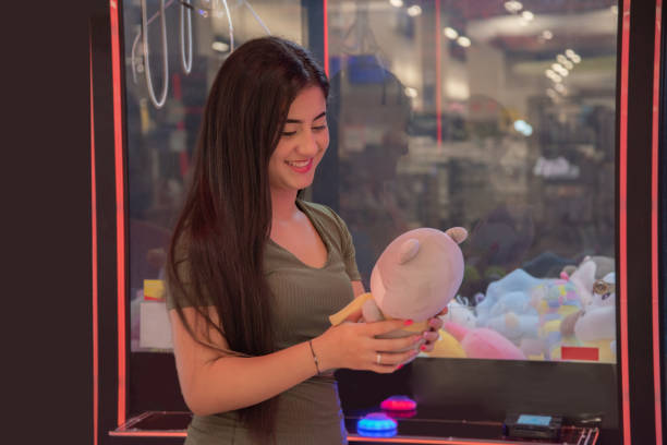 woman playing on the teddy bear machine