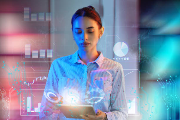 Businesswoman using artificial intelligence on the smart digital tablet device in futuristic office to generate financial data