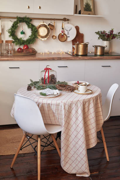 istock Christmas kitchen and table. Red, green and white decor christmas tree background. New Year celebration. Merry Christmas and Happy New Year. 2190042894