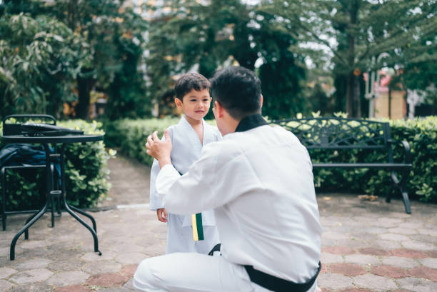 istock martial artist toddler working out with trainer 2190048232