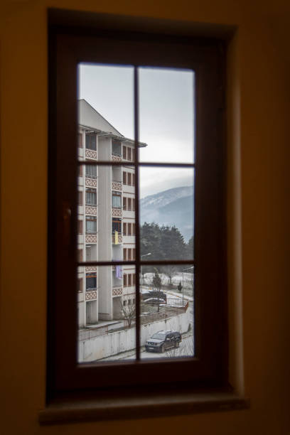 istock Window and view of outside from inside while it is snowing outside, landscape. framed window. 2190050631