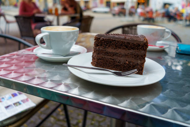 istock Slice of Chocolate Cake and Coffee on Cafe Table 2190053452