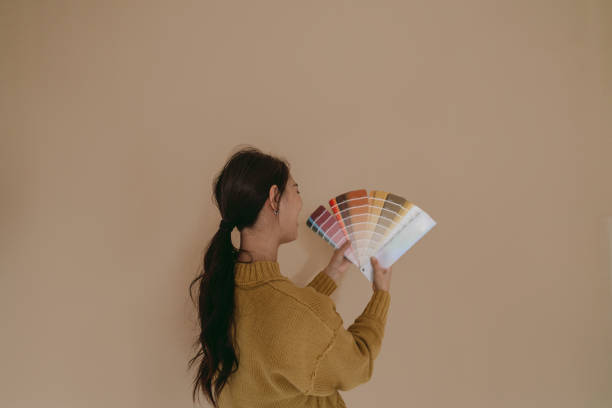 istock Choosing a wall paint shade from a colour swatch 2190057661