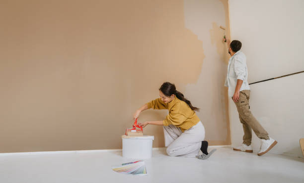 istock Couple painting a wall together during home renovation 2190057663