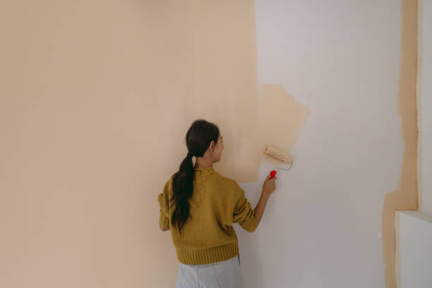 istock DIY: A woman's painting her own apartment 2190057670