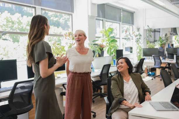 istock Business women having a light chat in a modern office environment 2190063663