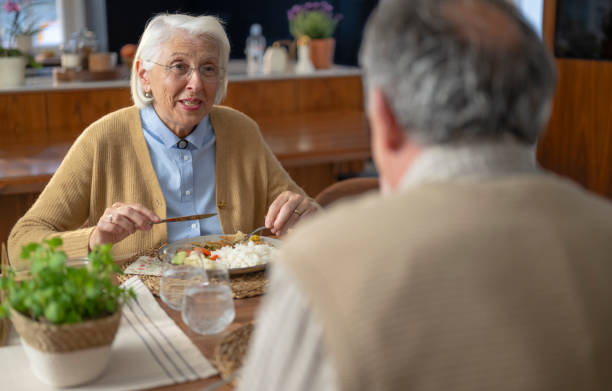 istock Elderly Couple Enjoying a Meal Together 2190070637