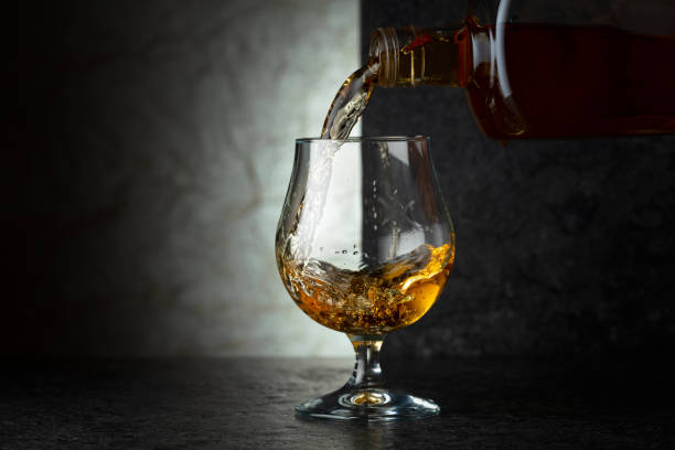 istock Pouring brandy from a bottle into a glass. 2190074511