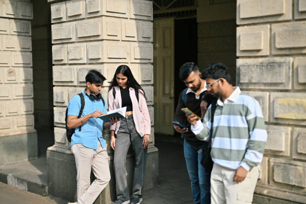 istock Group of university students standing and talking to each other in the campus 2190074987
