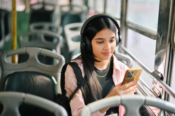 istock Young woman student attending her online class while commuting on a bus 2190075117