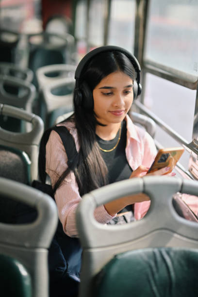 istock Young woman student attending her online class while commuting on a bus 2190075121