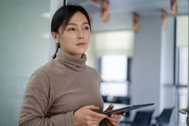 istock asian businesswoman using digital tablet in office 2190076682