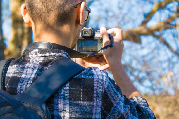 A man is hiking in the mountain, photographing nature