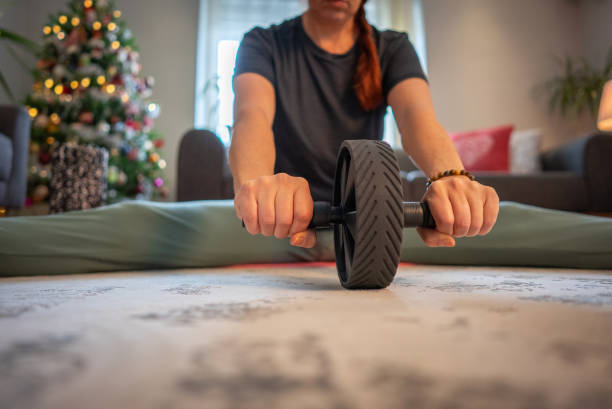 istock A woman works her abs with an ab roller 2190079453