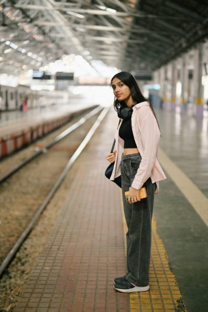 istock College girl standing at the platform, waiting for the train 2190080607