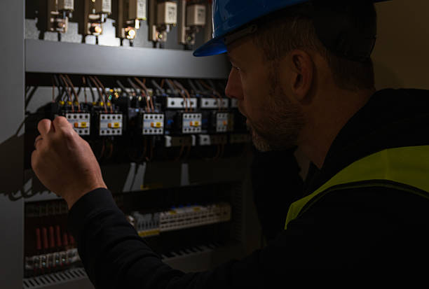 istock Worker in helmet shine with light and control circuit breaker. Electricity blackout, maintenance background 2190081664