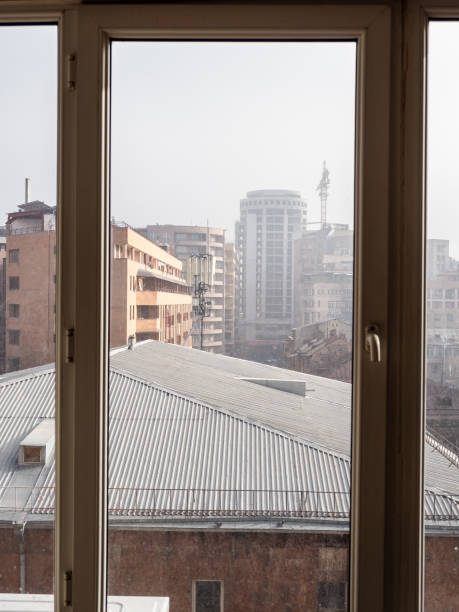 istock view through home window glass on houses in smog 2190082662