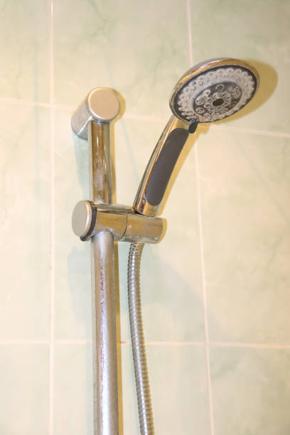 istock Shower head with limescale in the holder on the bathroom wall 2190083748