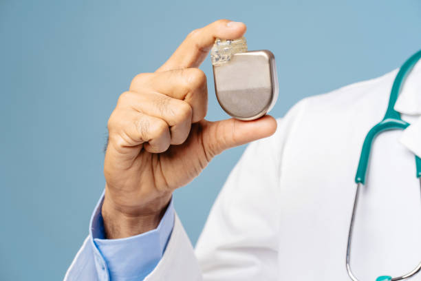 istock Portrait of professional doctor, cardiologist holding pacemaker selective focus on hands, closeup 2190085101