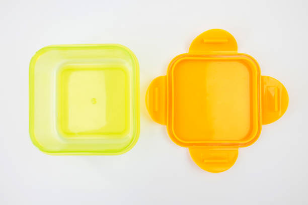 istock empty open plastic lunch box isolated on white background. Yellow container for school lunches. View from above. 2190090906