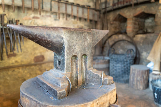 Hammer resting on anvil in blacksmith workshop, ready for forging metal