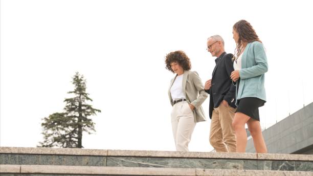 istock Confident business people walking and discussing outside office 2190093458