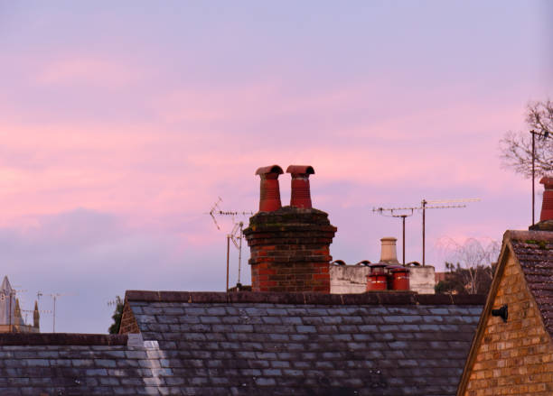 house chimney with a purple sunset behind