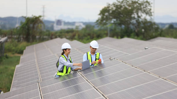 Two solar engineers are inspecting the solar farm site thoroughly. They focus on implementing zero-carbon credit strategies and promoting green energy initiatives. Their expertise and dedication are crucial in advancing sustainable energy solutions.