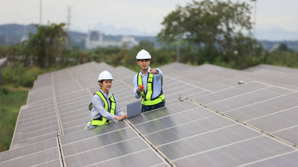 istock Two solar engineers are inspecting the solar farm site thoroughly. They focus on implementing zero-carbon credit strategies and promoting green energy initiatives. Their expertise and dedication are crucial in advancing sustainable energy solutions. 2190100407