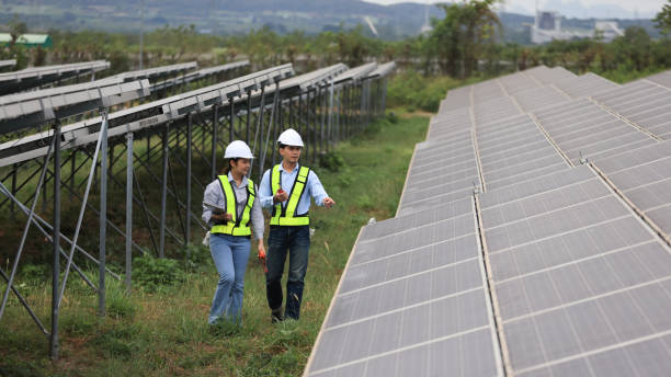 istock Two solar engineers are inspecting the solar farm site thoroughly. They focus on implementing zero-carbon credit strategies and promoting green energy initiatives. Their expertise and dedication are crucial in advancing sustainable energy solutions. 2190100420