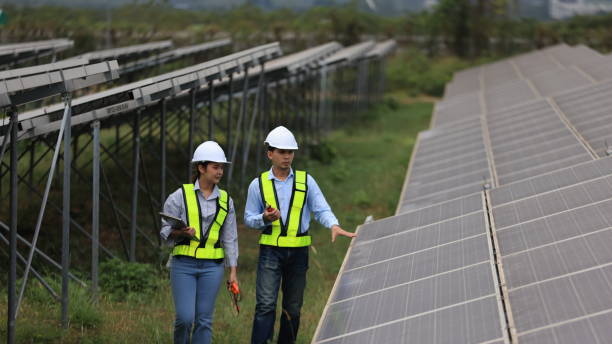 Two solar engineers are inspecting the solar farm site thoroughly. They focus on implementing zero-carbon credit strategies and promoting green energy initiatives. Their expertise and dedication are crucial in advancing sustainable energy solutions.