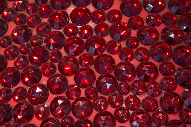 A texture background of glittering fake ruby gemstones captured in a close-up showcasing the vibrant red hues and intricate facets of these synthetic jewels affordable alternatives to natural rubies.