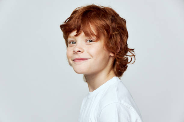 istock Cheerful redhead boy smile white t-shirt cropped view studio 2190103863
