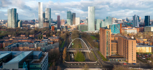 Panoramic aerial image of Manchester Skyline over Princess Rd showing Hulme Arch and the downtown cityscape.