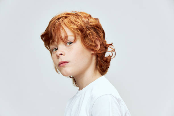 istock redhead child cropped side view close-up gray 2190104463