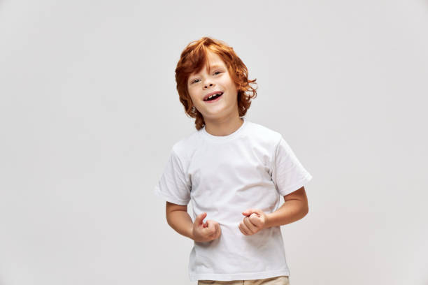 funny child smile white t-shirt studio gray isolated background childhood