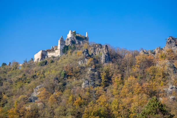 Autumn colors in the mountain forest. Wachau valley and vine yards in Austria. Rock formations in the yellow leaves autumn colored forest