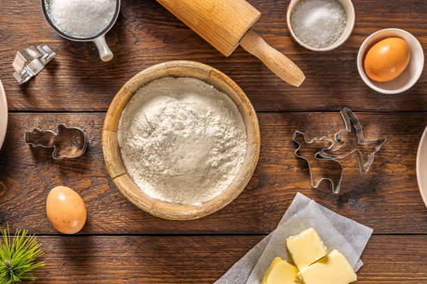 istock Christmas Cookie Baking Ingredients on Wooden Table 2190112331