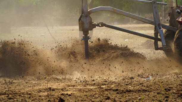 istock Tractor Spreading Fertilizer on Farmland with Dust in Motion 2190113136
