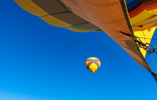 A hot air balloon rises above Lovers Hill in Göreme as dozens of onlookers capture the moment with their phones. The early morning light glows on Cappadocia’s landscape, blending modern fascination with ancient volcanic scenery.