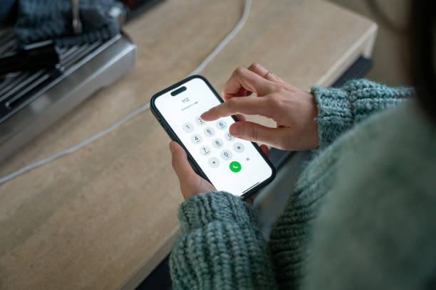 istock Woman dialing emergency number 112 on smartphone 2190114472