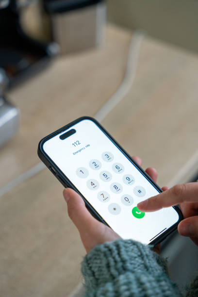 istock Woman dialing emergency number 112 on smartphone 2190114474