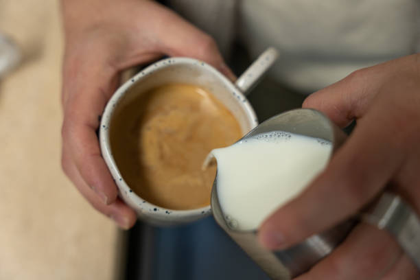istock Barista pouring milk into a coffee cup, making latte art 2190114627
