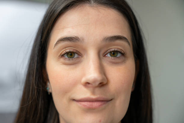 istock Young woman with hazel eyes smiling slightly and looking at camera 2190115225