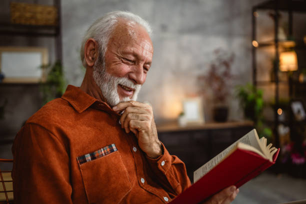 istock senior man enjoy in the living room while read a book 2190115448