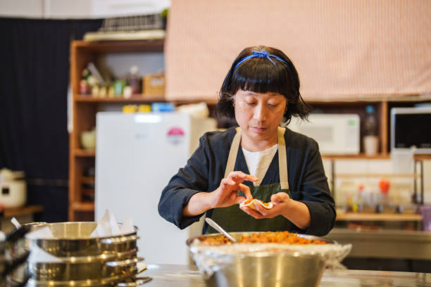 Filling Korean dumplings with rice noodles.